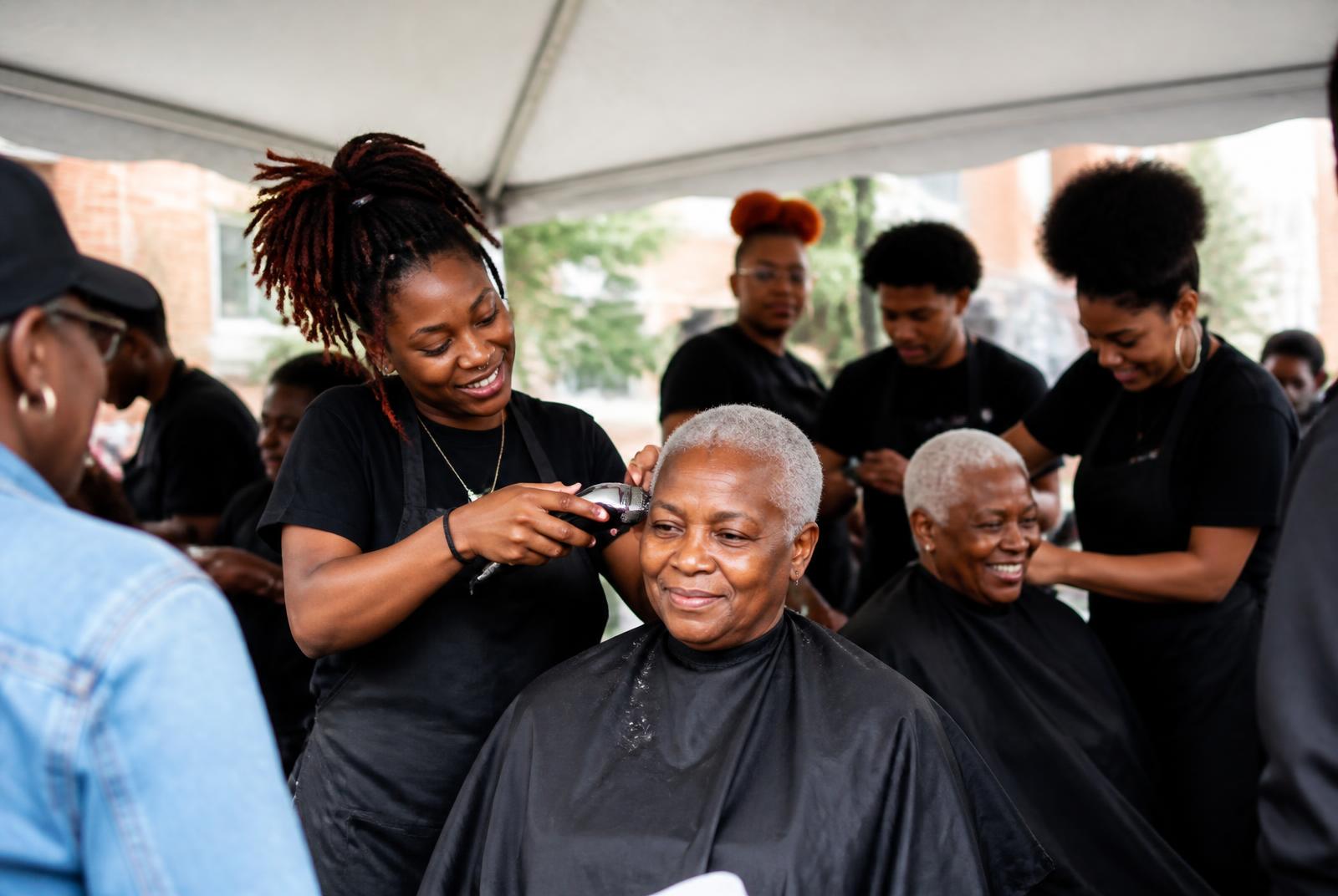 Students volunteering at a community outreach haircut event